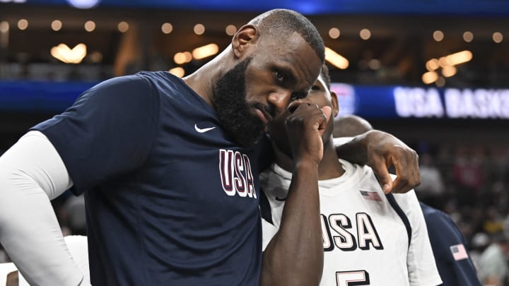 LeBron James and Anthony Edwards speak on the bench in the fourth quarter against Canada in the USA Basketball Showcase at T-Mobile Arena.