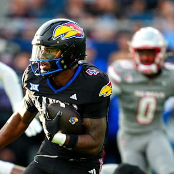 Sep 13, 2024; Kansas City, Kansas, USA; Kansas Jayhawks running back Devin Neal (4) runs the ball during the first half against the UNLV Rebels at Children's Mercy Park. Mandatory Credit: Jay Biggerstaff-Imagn Images