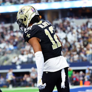 Sep 15, 2024; Arlington, Texas, USA;  New Orleans Saints wide receiver Chris Olave (12) celebrates with New Orleans Saints wide receiver Rashid Shaheed (22) during the first quarter against the Dallas Cowboys at AT&T Stadium. Mandatory Credit: Kevin Jairaj-Imagn Images