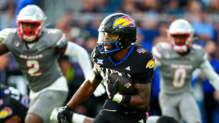 Sep 13, 2024; Kansas City, Kansas, USA; Kansas Jayhawks running back Devin Neal (4) runs the ball during the first half against the UNLV Rebels at Children's Mercy Park. Mandatory Credit: Jay Biggerstaff-Imagn Images