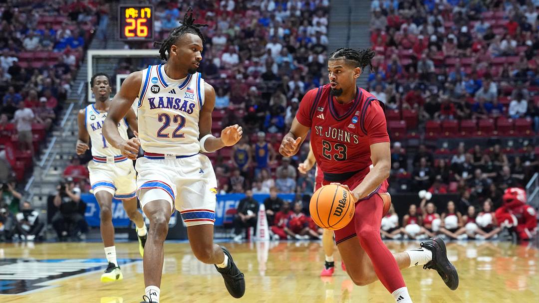 Mar 22, 2026; San Diego, CA, USA; St. John's Red Storm forward Bryce Hopkins (23) controls the ball against Kansas Jayhawks guard Darryn Peterson (22) in the first half during a second round game of the men's 2026 NCAA Tournament at Viejas Arena. Mandatory Credit: Kirby Lee-Imagn Images