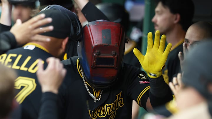 Apr 18, 2026; Pittsburgh, Pennsylvania, USA;  Pittsburgh Pirates designated hitter Marcell Ozuna (24) celebrates his  solo home run in the dugout while wearing a welders hood against the Tampa Bay Rays during the fourth inning at PNC Park. Mandatory Credit: Charles LeClaire-Imagn Images