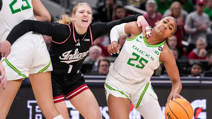 Oregon Ducks guard Deja Kelly (25) rushes past Indiana Hoosiers guard Lexus Bargesser (1) on Thursday, March 6, 2025, during the Big Ten women's tournament at Gainbridge Fieldhouse in Indianapolis. Oregon Ducks guard Deja Kelly (25) rushes past Indiana Hoosiers guard Lexus Bargesser (1) on Thursday, March 6, 2025, during the Big Ten women's tournament at Gainbridge Fieldhouse in Indianapolis.