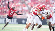 Louisville Cardinals linebacker Kalib Perry stops Bowling Green Falcons running back Chris McMillian as the Cards (3-0) cruised past Bowling Green 40-17 in football Saturday, Sept. 20, 2025, in Louisville, Kentucky