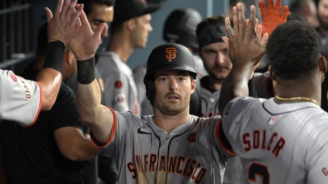 Jul 24, 2024; Los Angeles, California, USA;   San Francisco Giants right fielder Mike Yastrzemski (5) is greeted in the dugout after scoring a run in the eighth inning against the Los Angeles Dodgers at Dodger Stadium. Mandatory Credit: Jayne Kamin-Oncea-USA TODAY Sports