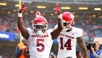  Kyle Monangai #5 of the Rutgers Scarlet Knights celebrates his second quarter rushing touchdown with Isaiah Washington #14 \V during the Bad Boy Mowers Pinstripe Bowl at Yankee Stadium on December 28, 2023 in New York City.