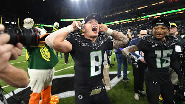 Dec 7, 2024; Indianapolis, IN, USA; Oregon Ducks quarterback Dillon Gabriel (8) and wide receiver Tez Johnson (15) celebrate 