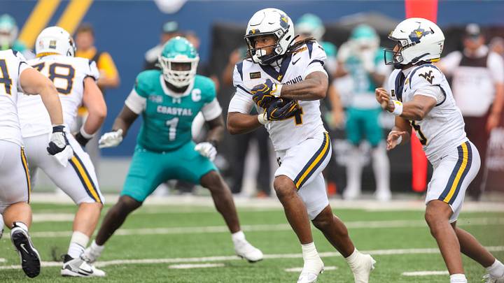 Sep 5, 2026; Morgantown, West Virginia, USA;  West Virginia Mountaineers running back Cam Cook (4) runs the ball during the fourth quarter against the Coastal Carolina Chanticleers at Milan Puskar Stadium.  Mandatory Credit: Ben Queen-Imagn Images