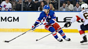 May 30, 2024; New York, New York, USA; New York Rangers left wing Artemi Panarin (10) skates with the puck as Florida Panthers defenseman Brandon Montour (62) defends during the third period in game five of the Eastern Conference Final of the 2024 Stanley Cup Playoffs at Madison Square Garden. Mandatory Credit: Dennis Schneidler-Imagn Images