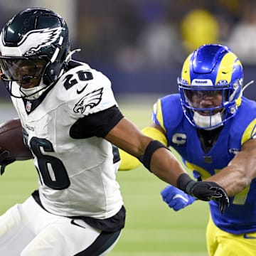 Nov 24, 2024; Inglewood, California, USA;  Philadelphia Eagles running back Saquon Barkley (26) runs past Los Angeles Rams safety Quentin Lake (right) during the second half at SoFi Stadium. Mandatory Credit: Alex Gallardo-Imagn Images