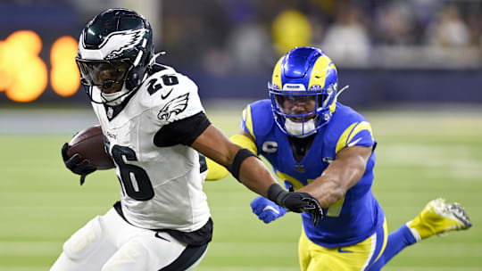 Nov 24, 2024; Inglewood, California, USA;  Philadelphia Eagles running back Saquon Barkley (26) runs past Los Angeles Rams safety Quentin Lake (right) during the second half at SoFi Stadium. Mandatory Credit: Alex Gallardo-Imagn Images