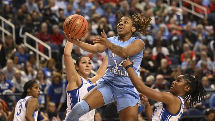 Mar 3, 2023; Greensboro, NC, USA; North Carolina Tar Heels guard Kayla McPherson (14) drives against Duke Blue Devils forward Taya Corosdale (5) and Duke Blue Devils guard Shayeann Day-Wilson (30) during the first half at Greensboro Coliseum. Mandatory Credit: William Howard-USA TODAY Sports