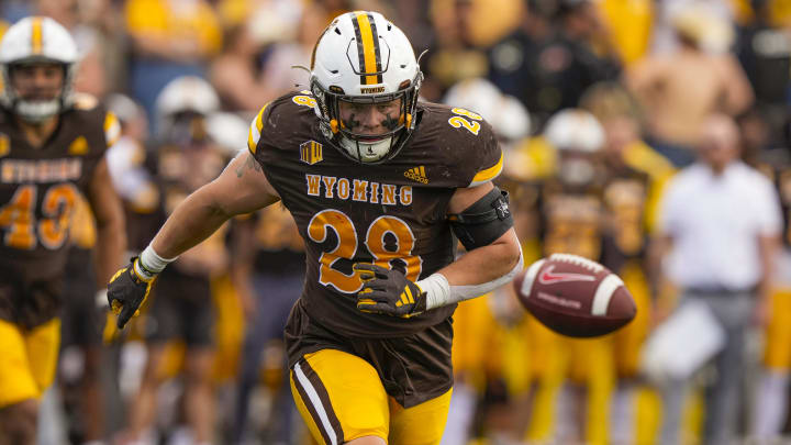 Sep 30, 2023; Laramie, Wyoming, USA; Wyoming Cowboys linebacker Easton Gibbs (28) looks to pick up a loose ball against the New Mexico Lobos during the third quarter at Jonah Field at War Memorial Stadium. Mandatory Credit: Troy Babbitt-USA TODAY Sports

