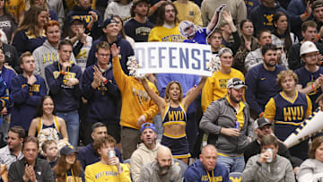 Feb 25, 2025; Morgantown, West Virginia, USA; A West Virginia Mountaineers cheerleader performs during the second half against the TCU Horned Frogs at WVU Coliseum. Mandatory Credit: Ben Queen-Imagn Images