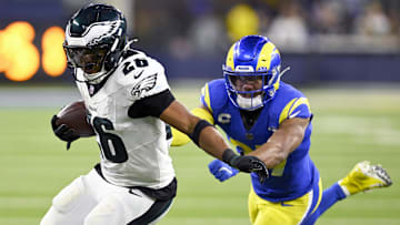 Nov 24, 2024; Inglewood, California, USA;  Philadelphia Eagles running back Saquon Barkley (26) runs past Los Angeles Rams safety Quentin Lake (right) during the second half at SoFi Stadium. Mandatory Credit: Alex Gallardo-Imagn Images