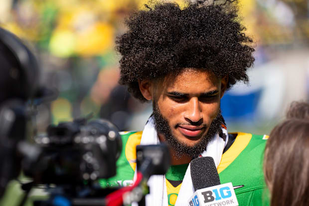 Oregon quarterback Dante Moore speaks to a television reporter as the Oregon Ducks host the Montana State Bobcats on Aug. 30,