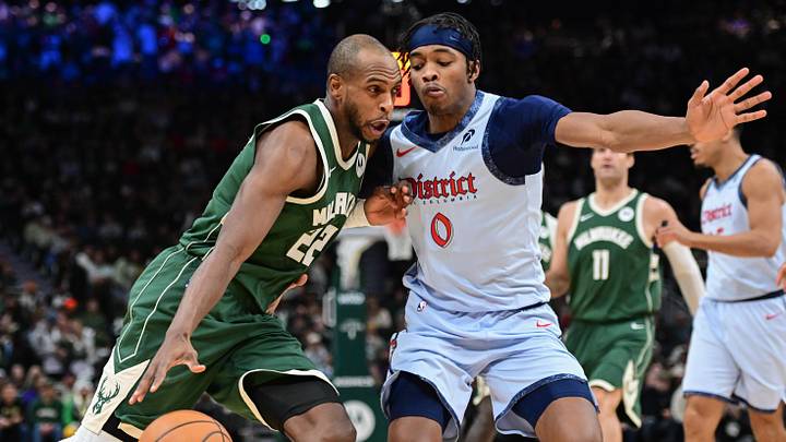 Dec 21, 2024; Milwaukee, Wisconsin, USA;  Milwaukee Bucks forward Khris Middleton (22) drives to the basket against Washington Wizards forward Bilal Coulibaly (0) in the second quarter at Fiserv Forum. Mandatory Credit: Benny Sieu-Imagn Images