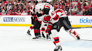 New Jersey Devils defenseman Luke Hughes clutches his shoulder after an injury during Game 1 vs. the Carolina Hurricanes.