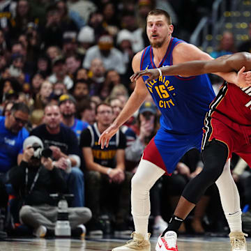 Nov 8, 2024; Denver, Colorado, USA; Miami Heat center Bam Adebayo (13) and Denver Nuggets center Nikola Jokic (15) battle for position on the court in the second half at Ball Arena. Mandatory Credit: Ron Chenoy-Imagn Images