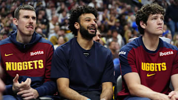 Apr 6, 2025; Denver, Colorado, USA; Denver Nuggets forward Vlatko Cancar (31), guard Jamal Murray (27) and center PJ Hall (13) on the bench during the fourth quarter against the Indiana Pacers at Ball Arena. Mandatory Credit: Ron Chenoy-Imagn Images