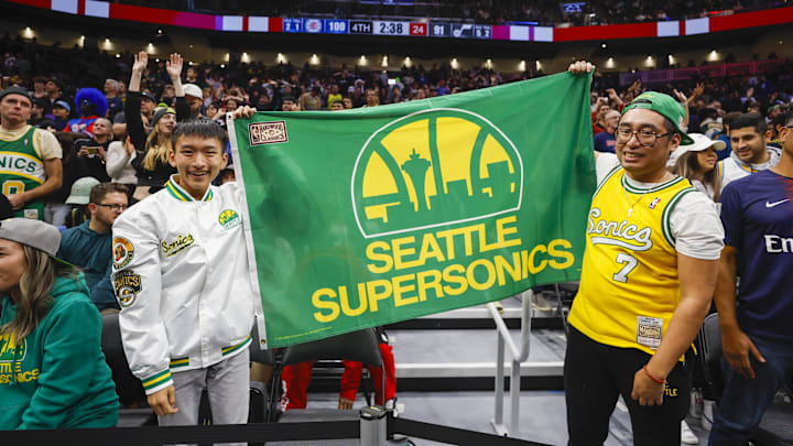 Oct 10, 2023; Seattle, Washington, USA; Fans hold a flag for the Seattle Supersonics during the fourth quarter of a game between the Utah Jazz and LA Clippers at Climate Pledge Arena.