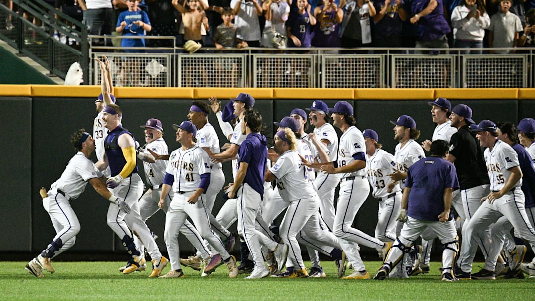Jun 18, 2025; Omaha, Neb, USA;  LSU Tigers players celebrate with first baseman Jared Jones (22) (no shirt) after the win against the Arkansas Razorbacks at Charles Schwab Field. Mandatory Credit: Steven Branscombe-Imagn Images