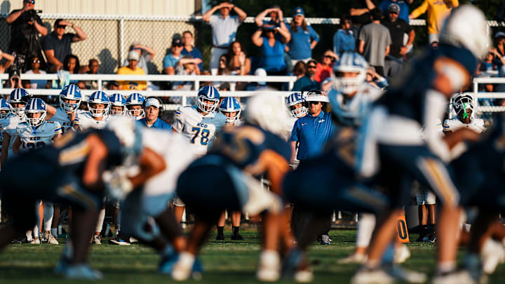 KCD players and fans watch the first quarter action under a bright setting sun during the game against Sayre. The Bearcats defeated the defending 2024 Class A state champ Spartans 31-28 in Lexington, Kentucky during the KHSAA Class A high school football season opener. August 22, 2025