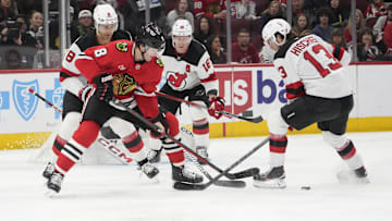 Mar 26, 2025; Chicago, Illinois, USA; Chicago Blackhawks center Ryan Donato (8) and New Jersey Devils center Nico Hischier (13) go for the puck during the first period at United Center. Mandatory Credit: David Banks-Imagn Images