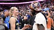 Dallas Mavericks point guard Kyrie Irving talks with Dallas Wings guard Paige Bueckers after a game.