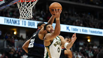Mar 7, 2024; Denver, Colorado, USA; Boston Celtics forward Jayson Tatum (0) shoots the ball past Denver Nuggets forward Zeke Nnaji (22) in the second half at Ball Arena. Mandatory Credit: Ron Chenoy-USA TODAY Sports