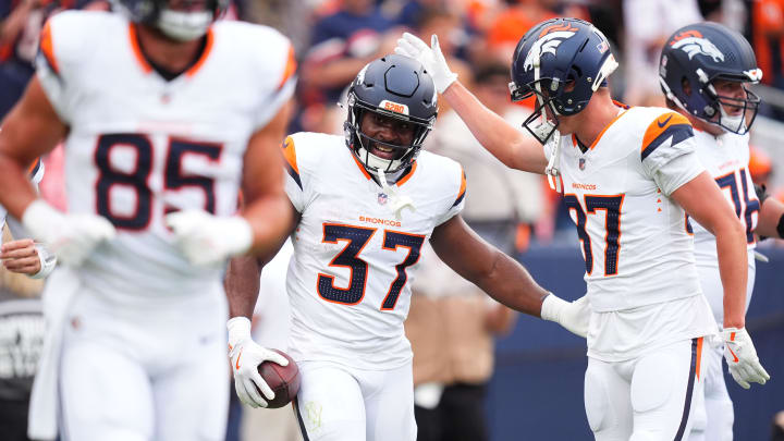 Aug 25, 2024; Denver, Colorado, USA; Denver Broncos running back Audric Estime (37) celebrates his touchdown with wide receiver David Sills V (87) in the first quarter against the Arizona Cardinals at Empower Field at Mile High. 