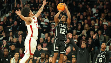 Jan 29, 2025; Starkville, Mississippi, USA; Mississippi State Bulldogs guard Josh Hubbard (12) shoots as Alabama Crimson Tide guard Aden Holloway (2) defends during the second half at Humphrey Coliseum. Mandatory Credit: Wesley Hale-Imagn Images