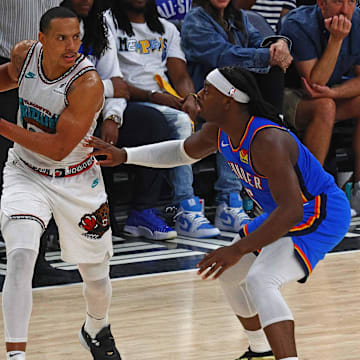 Apr 24, 2025; Memphis, Tennessee, USA; Memphis Grizzlies guard Desmond Bane (22) handles the ball as Oklahoma City Thunder guard Luguentz Dort (5) defends during the third quarter during game three for the first round of the 2025 NBA Playoffs at FedExForum. Mandatory Credit: Petre Thomas-Imagn Images