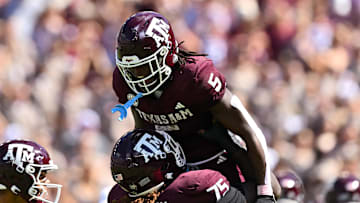 Oct 5, 2024; College Station, Texas, USA; Texas A&M Aggies offensive lineman Kam Dewberry (75) hoists running back Amari Daniels (5) after scoring a touchdown in the second quarter against the Missouri Tigers at Kyle Field. Mandatory Credit: Maria Lysaker-Imagn Images. 