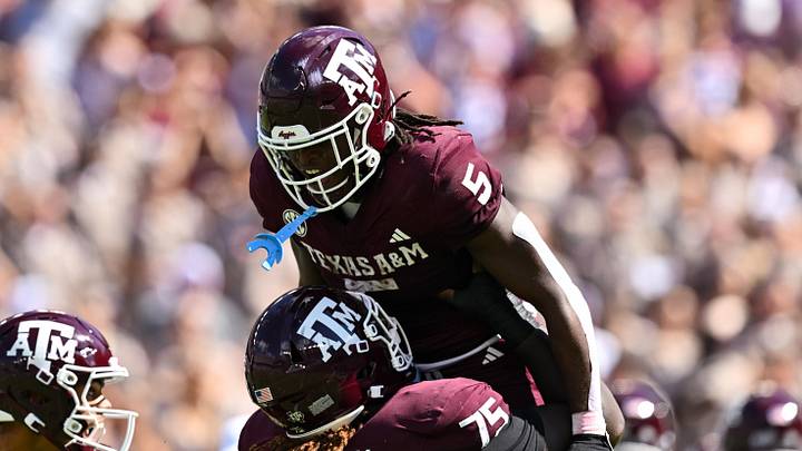 Oct 5, 2024; College Station, Texas, USA; Texas A&M Aggies offensive lineman Kam Dewberry (75) hoists running back Amari Daniels (5) after scoring a touchdown in the second quarter against the Missouri Tigers at Kyle Field. Mandatory Credit: Maria Lysaker-Imagn Images. 