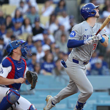 Apr 13, 2025; Los Angeles, California, USA; Chicago Cubs outfielder Kyle Tucker (30) hits a ground rule double against the Los Angeles Dodgers during the eighth inning of the game at Dodger Stadium. Mandatory Credit: Kiyoshi Mio-Imagn Images