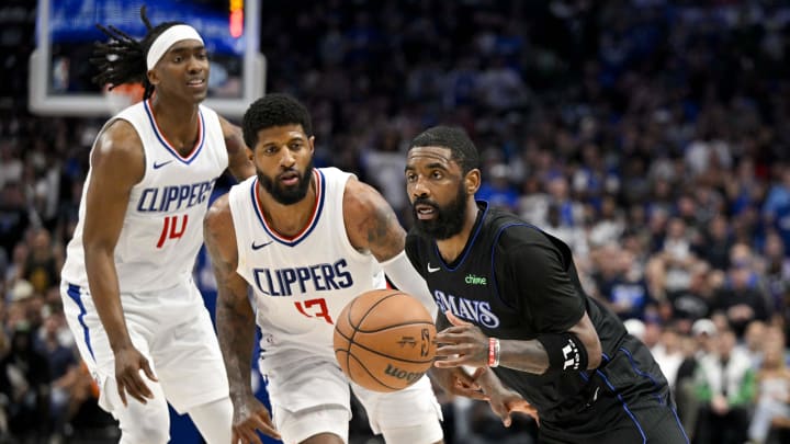 May 3, 2024; Dallas, Texas, USA; Dallas Mavericks guard Kyrie Irving (11) drives to the basket past LA Clippers guard Terance Mann (14) and forward Paul George (13) during the third quarter during game six of the first round for the 2024 NBA playoffs at American Airlines Center. Mandatory Credit: Jerome Miron-USA TODAY Sports