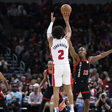 Feb 27, 2024; Chicago, Illinois, USA; Detroit Pistons guard Cade Cunningham (2) shoots against Chicago Bulls guard Ayo Dosunmu (12) during the second half at United Center. Mandatory Credit: Kamil Krzaczynski-Imagn Images