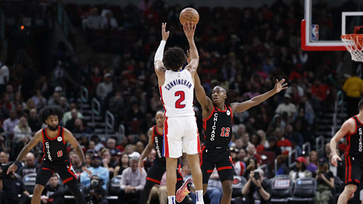 Feb 27, 2024; Chicago, Illinois, USA; Detroit Pistons guard Cade Cunningham (2) shoots against Chicago Bulls guard Ayo Dosunmu (12) during the second half at United Center. Mandatory Credit: Kamil Krzaczynski-Imagn Images