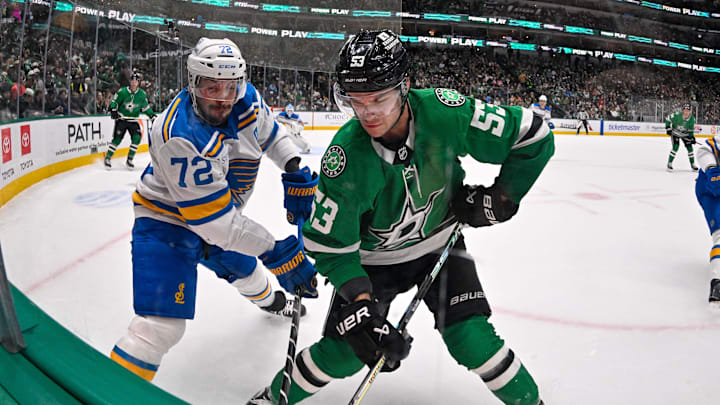 Jan 23, 2026; Dallas, Texas, USA; St. Louis Blues defenseman Justin Faulk (72) and Dallas Stars center Wyatt Johnston (53) battle for control of the puck during the second period at the American Airlines Center. Mandatory Credit: Jerome Miron-Imagn Images