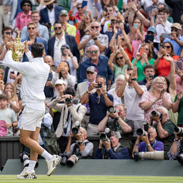 Carlos Alcaraz of Spain poses with the trophy after winning the men’s singles match against Novak Djokovic of Serbia.