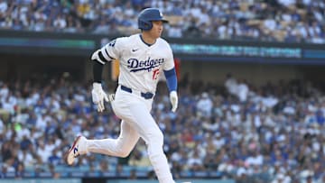 Apr 13, 2025; Los Angeles, California, USA; Los Angeles Dodgers designated hitter player Shohei Ohtani (17) runs to first base after hitting the ball into play during the fifth inning of the game at Dodger Stadium. Ohtani was out at first base on the play. Mandatory Credit: Kiyoshi Mio-Imagn Images