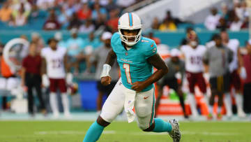 Aug 17, 2024; Miami Gardens, Florida, USA; Miami Dolphins quarterback Tua Tagovailoa (1) runs on the field after passing the football against the Washington Commanders during the first quarter of a preseason game at Hard Rock Stadium. Mandatory Credit: Sam Navarro-USA TODAY Sports