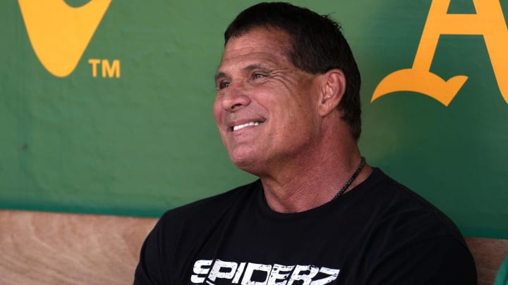 Aug 17, 2024; Oakland, California, USA; Oakland Athletics former outfielder Jose Canseco sits in the dugout before the game against the San Francisco Giants at Oakland-Alameda County Coliseum. Mandatory Credit: Darren Yamashita-USA TODAY Sports