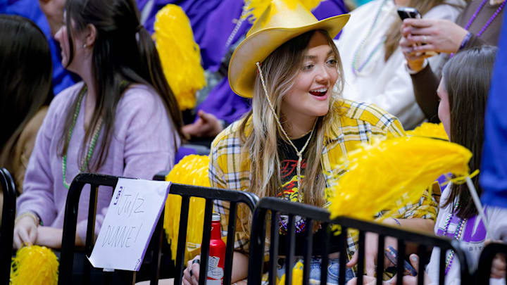 Feb 2, 2024; Baton Rouge, LA, USA;  Julz Dunne, the sister of LSU Lady Tigers senior Olivia Dunne cheers for her sister against the Arkansas Razorbacks at Pete Maravich Assembly Center. 