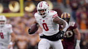 Nov 25, 2023; Minneapolis, Minnesota, USA; Wisconsin Badgers running back Braelon Allen (0) runs for a first down against the Minnesota Golden Gophers during the second quarter at Huntington Bank Stadium. 