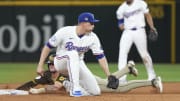 Jul 3, 2024; Arlington, Texas, USA; San Diego Padres center fielder Jackson Merrill (3) steals second base ahead of the tag by Texas Rangers shortstop Corey Seager (5) during the fifth inning at Globe Life Field. Mandatory Credit: Jim Cowsert-USA TODAY Sports