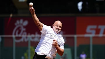 Apr 26, 2025; Denver, Colorado, USA; American former professional baseball player Dante Bichette throws out the first pitch before the game between the Cincinnati Reds against the Colorado Rockies at Coors Field. Mandatory Credit: Ron Chenoy-Imagn Images