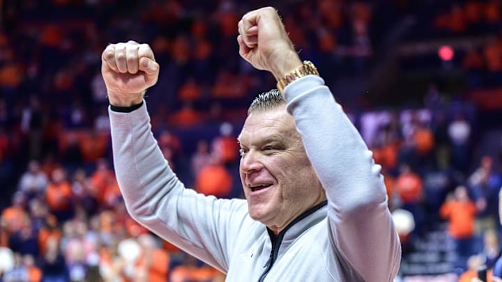 Jan 21, 2026; Champaign, Illinois, USA;  Illinois Fighting Illini head coach Brad Underwood greets fans as he enters the floor during pre-game introductions at State Farm Center in a matchup against the Maryland Terrapins.. Mandatory Credit: Fred Zwicky-Imagn Images