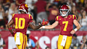 Sep 7, 2024; Los Angeles, California, USA; USC Trojans quarterback Miller Moss (7) celebrates with USC Trojans wide receiver Kyron Hudson (10) after scoring a touchdown against Utah State Aggies during the first quarter at United Airlines Field at Los Angeles Memorial Coliseum. Mandatory Credit: Jonathan Hui-Imagn Images